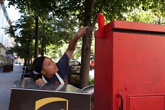 Jimia Williams, 17, prepares a utility box for a mural of Frida Kahlo at Monroe Center and Ionia