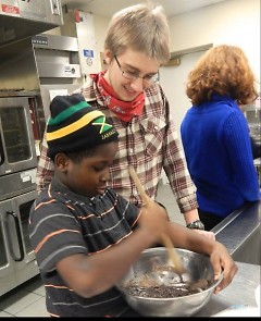 Calvin College students mentor neighborhood youth in Oakdale Neighbors' baking class.