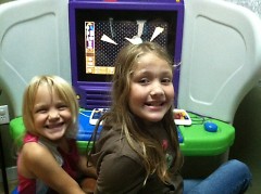 Two young guests play on a computer donated by IBM
