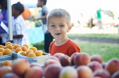 Fresh fruit, like the peaches here, are favorite among children at the YMCA Farmers Market.