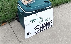 A sign reads "Stelma retires in shame" outside of Noto's on Friday night where the Sheriff's retirement party was held.