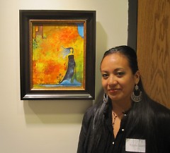 Artist Reyna Garcia with one of her paintings