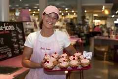 Laura Preston, assistant manager of Sweetie-licious Bakery Cafe displays a tray of cupcakes