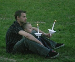 A man and his daughter sit close to each other for the entire vigil