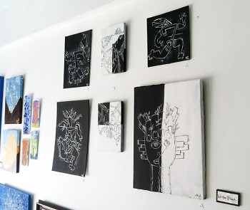 Black and white works on the wall at the studio