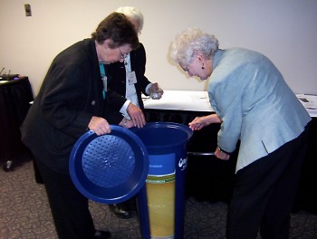 L to R: Sisters Mary Navarre, Ann Porter and Alice Wittenbach examine the BioSand Water Filter.