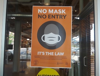 "No mask, no entry" sign at entrance of Downtown Market Grand Rapids.